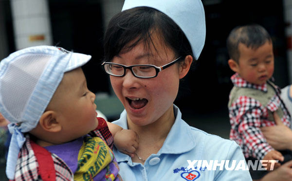5月11日，护士王丽和“地震宝宝”陈鑫涛在一起。